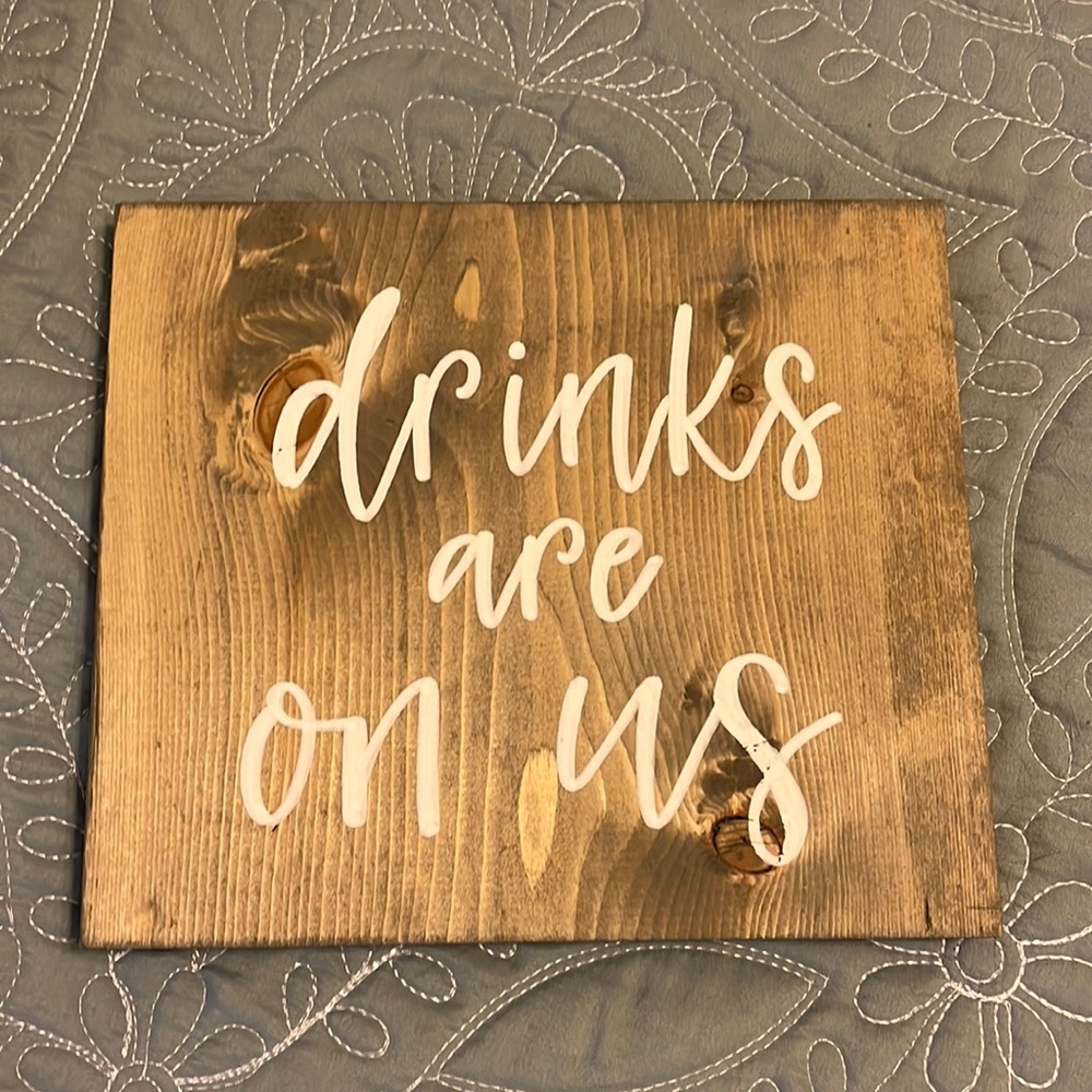 “Drinks are on us” open bar sign
